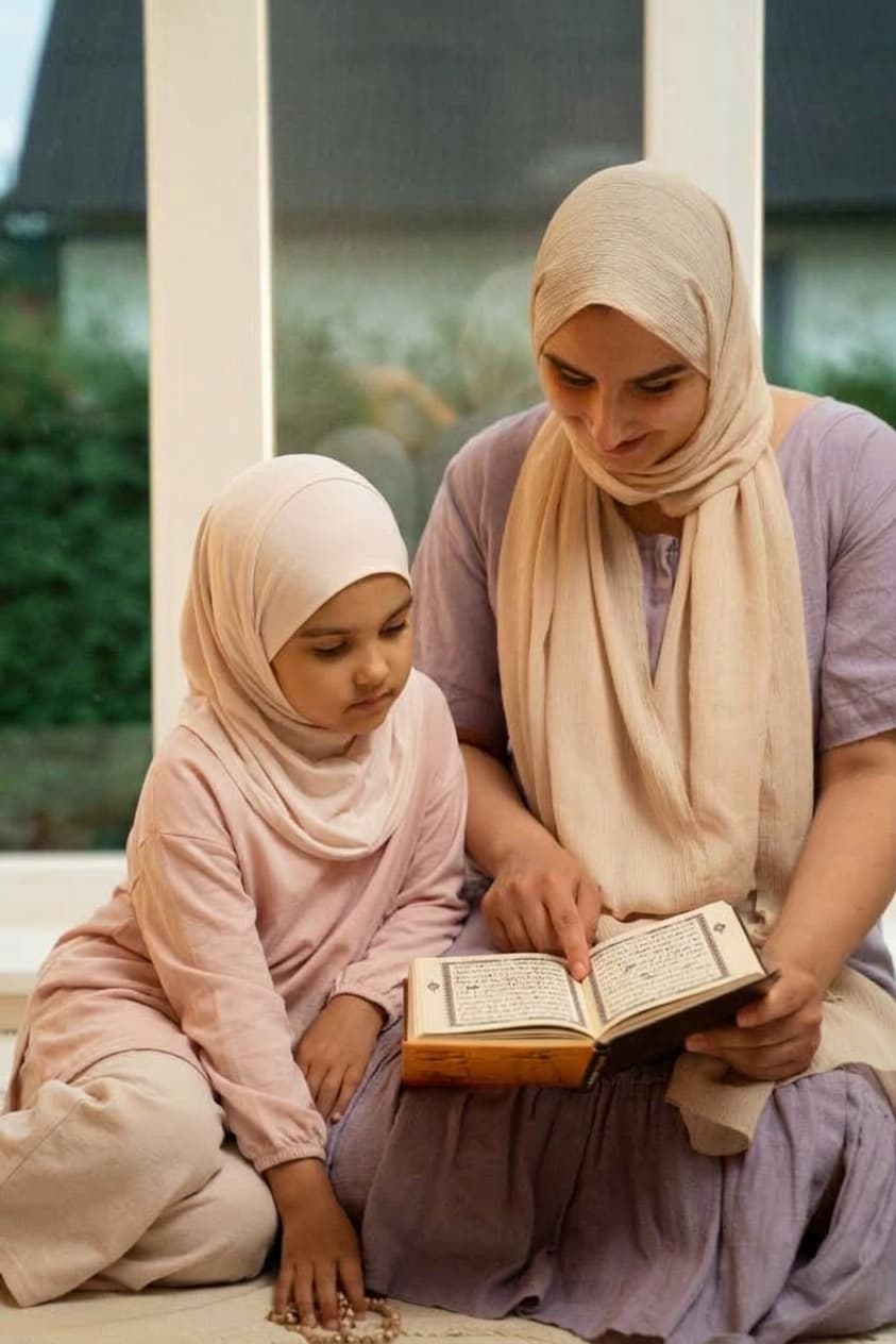 Mother holding her young daughter close as they read the Quran together at home
